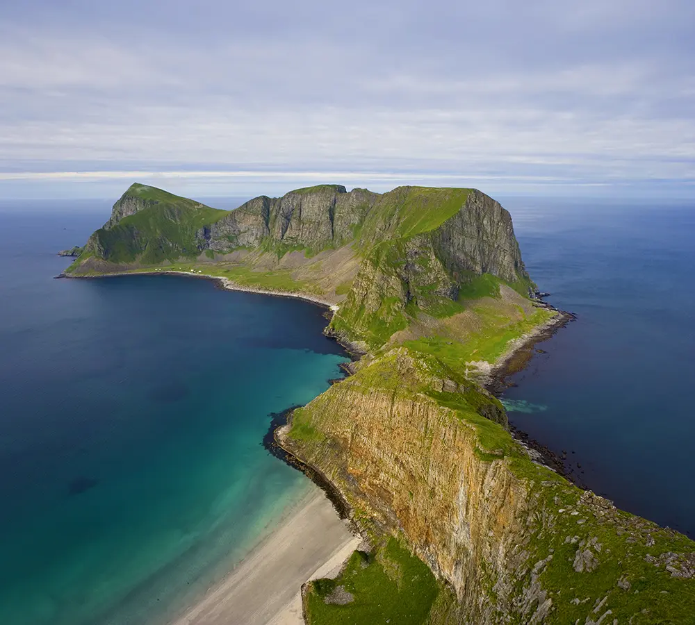 View from the mountain Håen towards Måstadvika and the vacated hamlet of Måstad on Værøy in Lofoten, Nordland. Northern Norway. Island in the sea. Coast and mountains. Coastal landscape in Northern Norway.